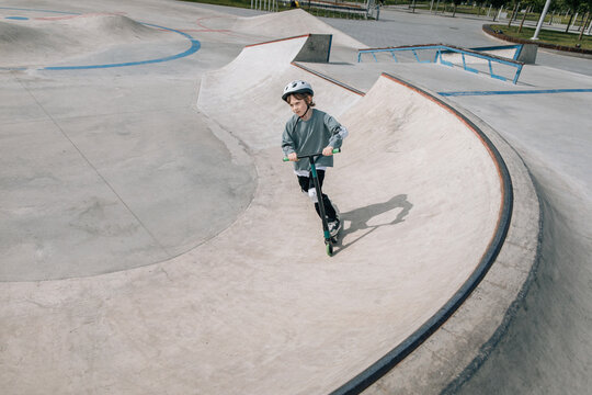 Child Enjoying Skateboarding at Fun Outdoor Park Setting