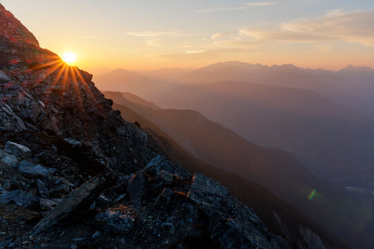 Calm scene of mountain range filled with rays of sunlight.