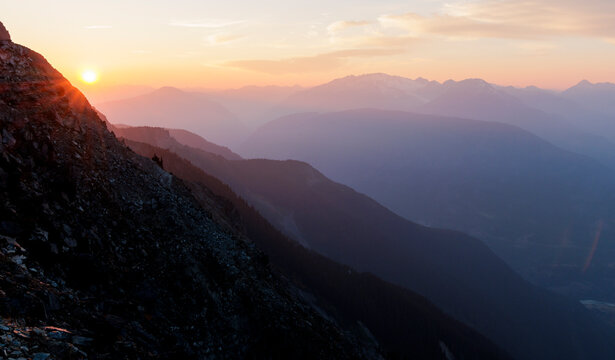 Calm scene of mountain range filled with rays of sunlight.