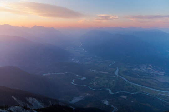 Deep Valley surround by tall mountain peaks at sunset