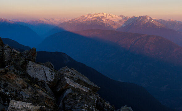 Sunrise over distant mountain with large glacier