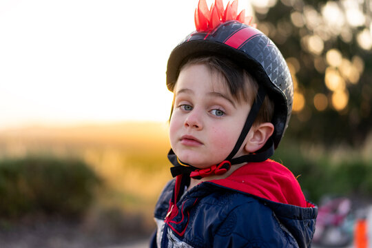 Young boy wearing a safety helmet at a park