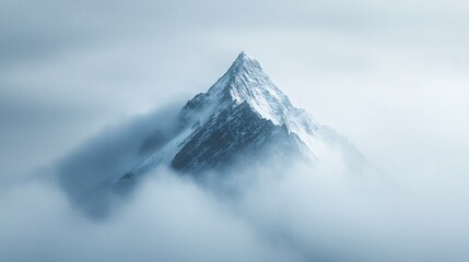 Snowy Mountain Peak Emerging from the Fog, Cold and Mysterious Landscape