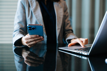 Businesswoman hand working digital marketing media in virtual screen with mobile phone and modern compute with VR icon diagram at office