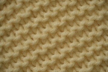 ivory texture of knitted wool fabric as a background, ivory smooth symmetrical braided cable knit pattern of hand-knitted needlework