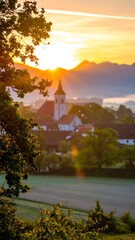 Sunrise over village church, mountain vista