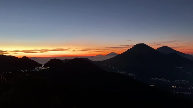 A beautiful sunrise over mountains, viewed from the top of Mount Bismo, in the Dieng Volcano Complex, Wonosobo Regency, Central Java, Indonesia.