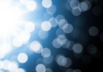 Obraz premium Soft blue bokeh lights with bright white glow and dark background