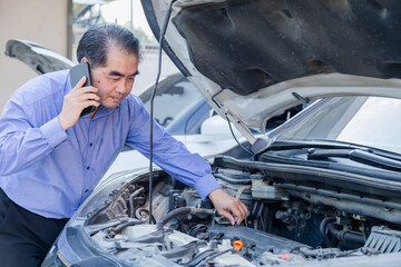 Garage small business or car insurance, middle-aged man calling for help while checking car engine, roadside situation reflecting breakdown problem, urgent communication for mechanical assistance