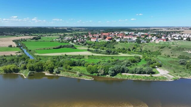 Aerial Gniew Poland Vistula River to castle fast. Northern Poland. Castle construction 13th century by Teutonic Knights. Vistula River. Agriculture land, river, forest and farm rural area.