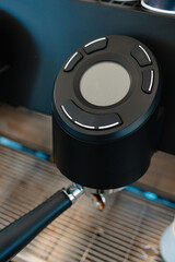 This sleek and modern espresso machine boasts a userfriendly control button, ideal for passionate coffee enthusiasts