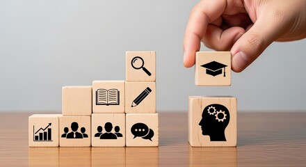 Hand placing graduation cap block on head with gears representing education and knowledge