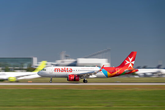 KM Malta Airlines Airbus A320neo with the aircraft registration 9H-NED during landing to the southern runway 26L of the Munich airport MUC EDDM