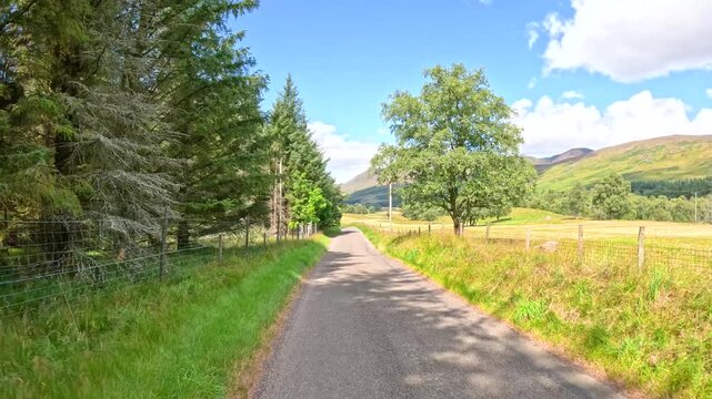 Sunny Drive Along Rural Country Road in Scottish Highlands