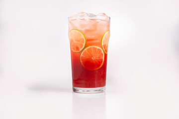 Red cocktail with lime. On a white background.