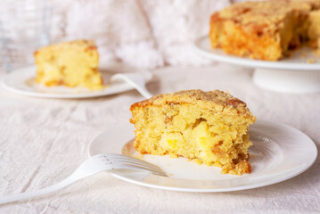 homemade apple streusel cake on white ceramic plate.