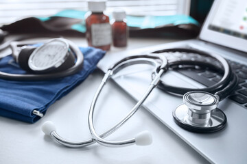 Stethoscope on laptop keyboard in doctor surgery