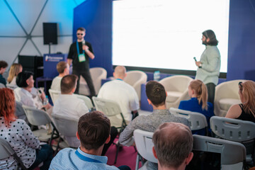 Fototapeta premium Audience listening to a professional speech during a conference in a modern environment