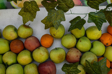 apples and oranges on market stall