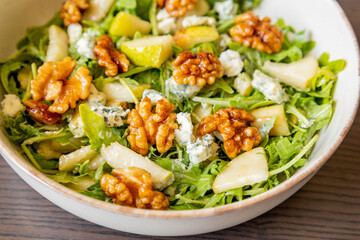 healthy fall salad with arugula pear cheese and candied walnuts