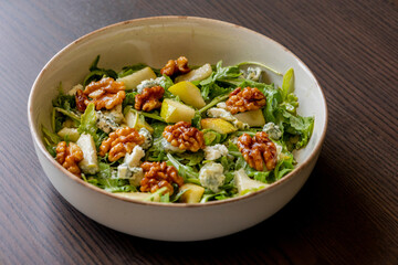 healthy fall salad with arugula pear cheese and candied walnuts