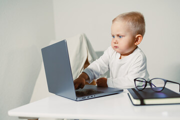 A Curious and Engaged Toddler Exploring a Laptop Take a Glimpse into the Fascinating Digital World that Early Childhood Technology Exposure Brings to Developing Young Minds and Their Future