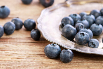Blueberries on brown wooden table.