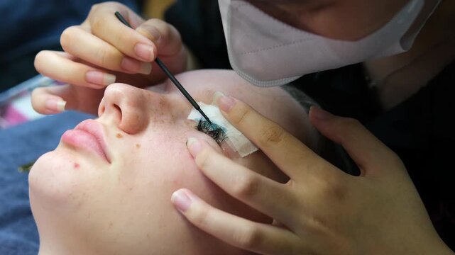Eyelash Extension Procedure. Woman Eye with Long Eyelashes. Lashes, close up, selective focus. High quality 4k footage