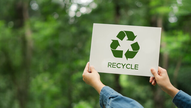 Recycle plastic free, sustainable environment, eco and save the earth concept. of zero waste, from waste to environment, Hand holding recycle symbol on green bokeh background