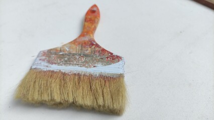 Close-up of a used paintbrush with white paint, symbolizing creativity and work tools. Perfect for blogs, design, DIY projects, education, or advertising.