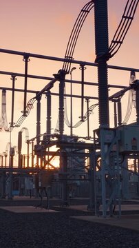 Electrical substation at sunset. The power grid infrastructure distributes electricity to homes and businesses. ABB equipment is visible. Energy production.