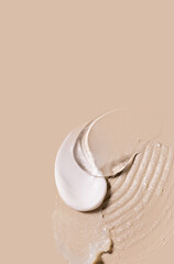 samples of cosmetic care products smear of cream gel texture on a beige background