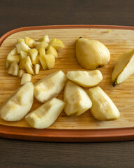 autumn pear slices on wooden cutting board healthy fruit