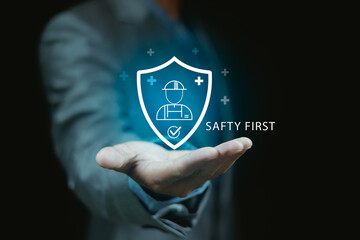 Workplace safety concept with digital inspection icon showing SAFETY FIRST Engineer using laptop to audit health and safety protocols in construction, industry, or manufacturing environment.
