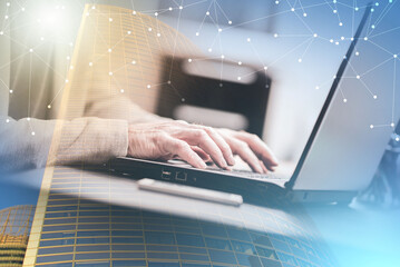 Hands of businessman using laptop; multiple exposure