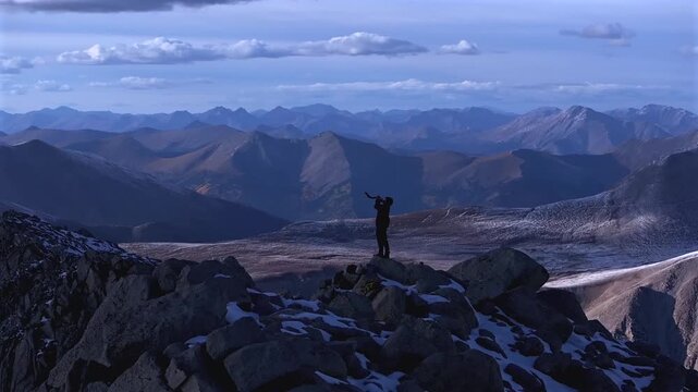 Shofar ram horn music blown from hiker top of Rocky Mountains summit Jewish Christian tradition Walls of Jericho Mt Mount Shavano Elbert Huron Peak Central Colorado aerial drone sunset snow parallax