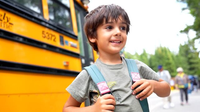 Young student standing at bus stop, wearing colorful backpack, waving cheerfully to parents before embarking on first day of elementary school, embodying childhood excitement and anticipation