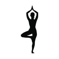 Fototapeta premium Silhouette of a Woman Practicing Yoga's Tree Pose Against a Black Background