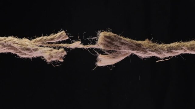 The Last Strand Of Rope Breaks On A Black Background
