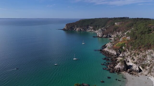 drone aerial view of a cliff, coas with sea and boats