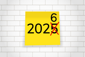 Obraz premium 2026. goals. plan. new year. A yellow sticky note with the number “2026” written in bold black font, placed on a squared notebook paper background.