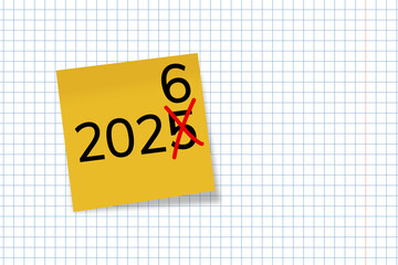 2026. goals. plan. new year. A yellow sticky note with the number “2026” written in bold black font, placed on a squared notebook paper background.