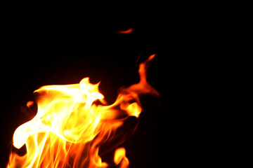 Close up burning flames on black background for graphic design or wallpaper.
