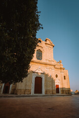 Baroque facade of Oria Cathedral with ornate details under summer sky