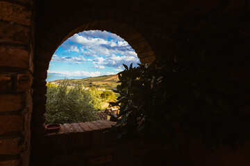 Wide countryside view of Abruzzo hills through farmhouse window in summer light