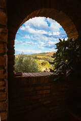 Framed view of Abruzzo hills through old farmhouse window in summer light