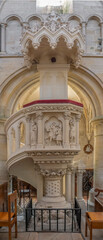Obraz premium Langrune-Sur-Mer, France - 08 05 2025: Detail view of an aisle and the stone chair from the central nave inside the Saint-Martin Church
