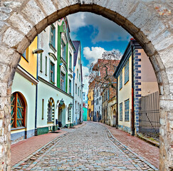 Narrow street with stone arch in old town