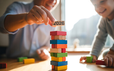 Father and child playing with colorful wooden blocks building a tower with the year 2026 symbolizing future goals and family time together in a bright and cheerful setting