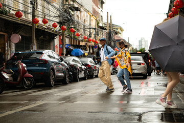 Happy senior couple walking on a city street, holding hands and sightseeing together